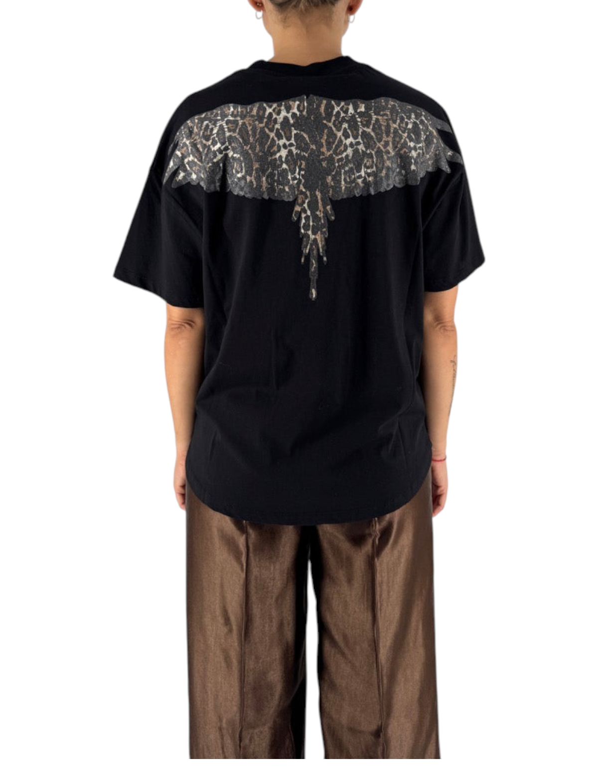 Modella di spalle indossa maglia DevidLabel in jersey nero con stampa grafica a ali animalier sul retro